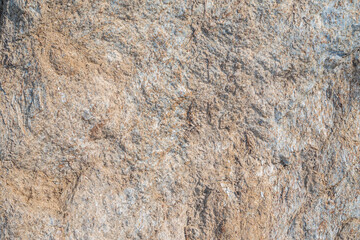 Detail of stone texture for background. Surface of the marble with brown tint