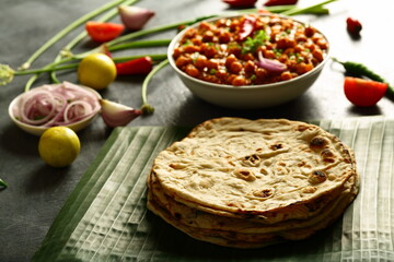 Whole-wheat  roti served with chickpeas curry, chana masla, - Indian vegetarian meal.