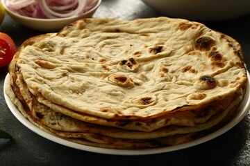 Indian  roti- whole wheat flat bread served with onion salad and chickpea curry.