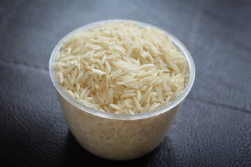 White rice in plastic bowl with blurred background