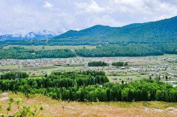 Fototapeta na wymiar Mountains and forests surround the natural scenery of Hemu village in Kanas, Xinjiang, China