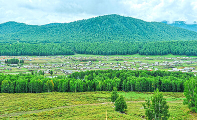 Beautiful panoramic view of Hemu village and birch forest mountain beside the village in burjin County, Xinjiang, China