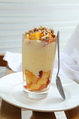 Dessert with peaches, butter cream and nuts