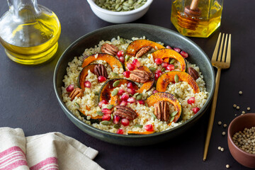 Bulgur with pumpkin, pomegranate and pecan nut. Healthy eating. Vegetarian food.