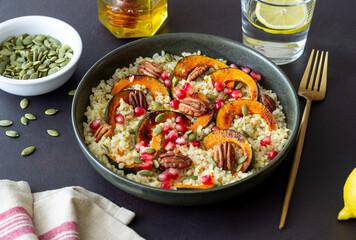 Bulgur with pumpkin, pomegranate and pecan nut. Healthy eating. Vegetarian food.