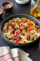 Bulgur with pumpkin, pomegranate and pecan nut. Healthy eating. Vegetarian food.