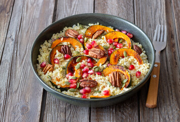 Bulgur with pumpkin, pomegranate and pecan nut. Healthy eating. Vegetarian food.