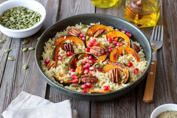 Bulgur with pumpkin, pomegranate and pecan nut. Healthy eating. Vegetarian food.