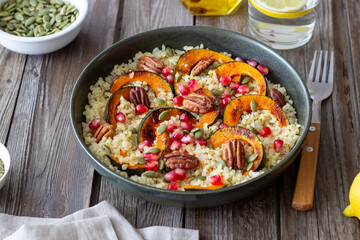 Bulgur with pumpkin, pomegranate and pecan nut. Healthy eating. Vegetarian food.