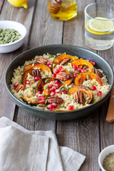 Bulgur with pumpkin, pomegranate and pecan nut. Healthy eating. Vegetarian food.