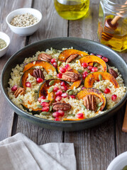 Bulgur with pumpkin, pomegranate and pecan nut. Healthy eating. Vegetarian food.