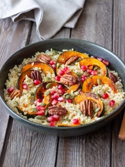 Bulgur with pumpkin, pomegranate and pecan nut. Healthy eating. Vegetarian food.