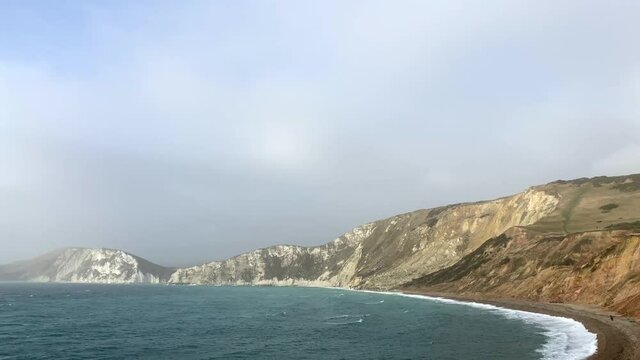 Aerial view panning across a beautiful coastal landscape in England