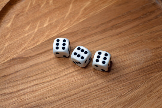 dice on old wood table white number risk game