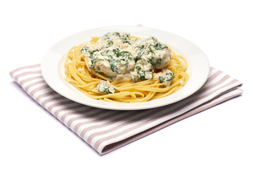 Portion of delicious meatballs with spinach in a creamy sauce and pasta