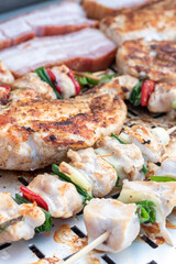 Chicken breast and pork meat pulled in wooden skewer with fresh colorful and tasty vegetables