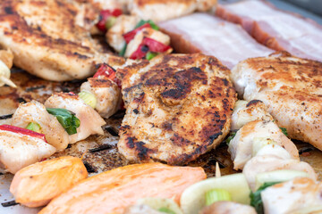 Chicken breast and pork meat pulled in wooden skewer with fresh colorful and tasty vegetables