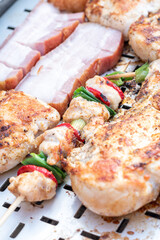 Chicken breast and pork meat pulled in wooden skewer with fresh colorful and tasty vegetables