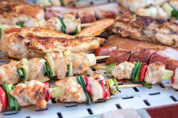 Chicken breast and pork meat pulled in wooden skewer with fresh colorful and tasty vegetables