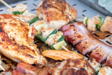 Chicken breast and pork meat pulled in wooden skewer with fresh colorful and tasty vegetables