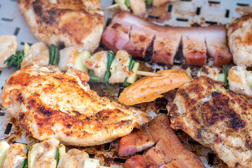 Chicken breast and pork meat pulled in wooden skewer with fresh colorful and tasty vegetables