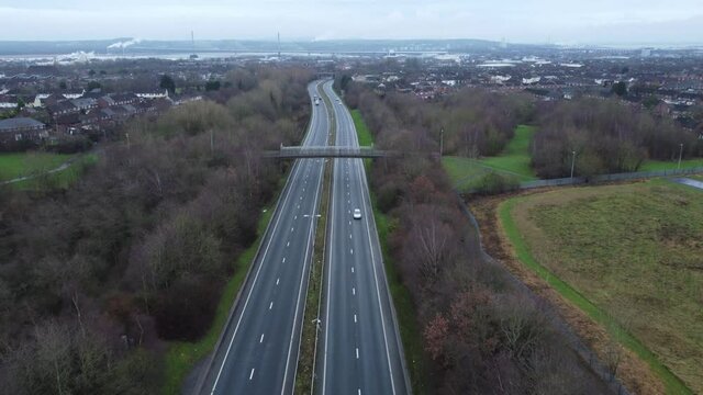 A557 Rainhill Runcorn Widnes expressway aerial view down British highway reversing shot