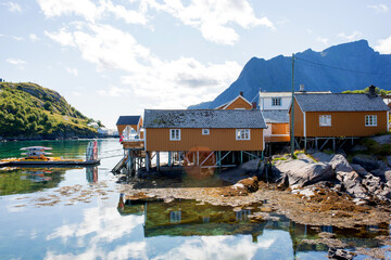 Amazing view of a norwegian beautiful nature and typical small fishing cabins on a sunny summer day over the fjords