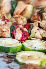 Chicken breast and pork meat pulled in wooden skewer with fresh colorful and tasty vegetables