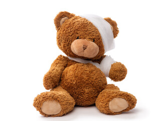 medicine, healthcare and childhood concept - teddy bear toy with bandaged head and paw on white background