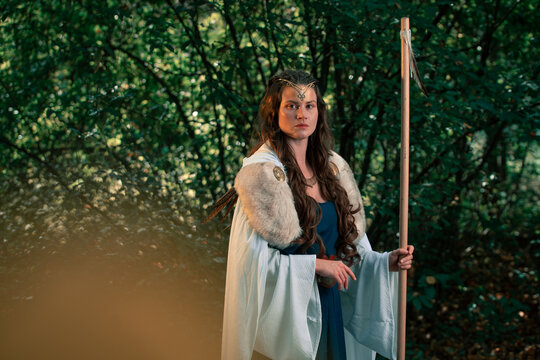 Gorgeous woman in old authentic historical outfit in forest