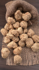 Raw soya chunks on dark background. Healthy, nutritious soybean meat, chunks isolated.Vegan food concept.
