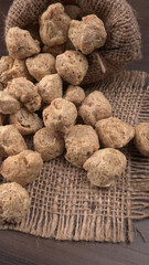 Raw soya chunks on dark background. Healthy, nutritious soybean meat, chunks isolated.Vegan food concept.
