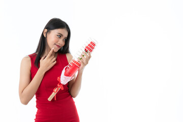 Sexy beautiful young Asian long hair  woman in casual business red dress is holding,  looking at red rose and  pointing cheek when feels happy and shy, isolated white background with copy space