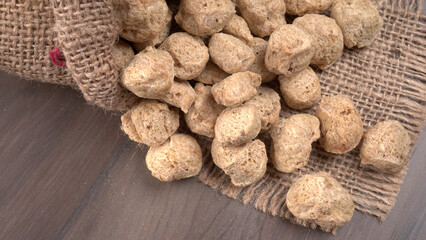 Raw soya chunks on dark background. Healthy, nutritious soybean meat, chunks isolated.Vegan food concept.
