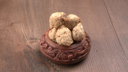 Raw soya chunks on dark background. Healthy, nutritious soybean meat, chunks isolated.Vegan food concept.
