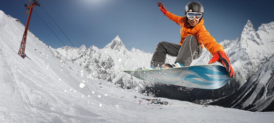 Fototapeta na wymiar Snowboarder jumping through air with deep blue sky in background. Sport background. Winter sport. 