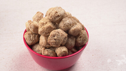 Raw soya chunks on dark background. Healthy, nutritious soybean meat, chunks isolated.Vegan food concept.
