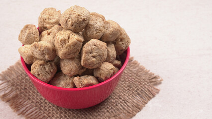 Raw soya chunks on dark background. Healthy, nutritious soybean meat, chunks isolated.Vegan food concept.
