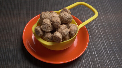 Raw soya chunks on dark background. Healthy, nutritious soybean meat, chunks isolated.Vegan food concept.
