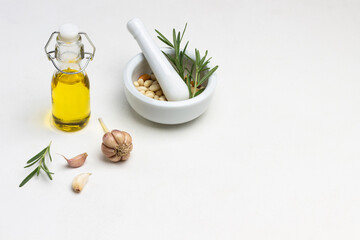 Fototapeta na wymiar Olive oil in bottle. Nuts in mortar.