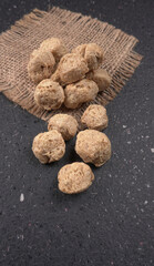 Raw soya chunks on dark background. Healthy, nutritious soybean meat, chunks isolated.Vegan food concept.