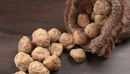 Raw soya chunks on dark background. Healthy, nutritious soybean meat, chunks isolated.Vegan food concept.