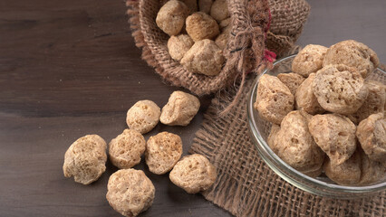 Raw soya chunks on dark background. Healthy, nutritious soybean meat, chunks isolated.Vegan food concept.
