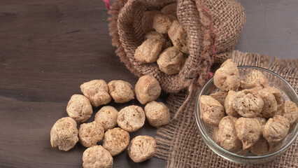 Raw soya chunks on dark background. Healthy, nutritious soybean meat, chunks isolated.Vegan food concept.