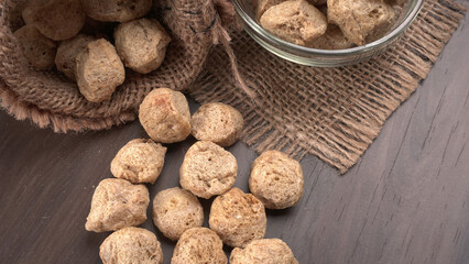Raw soya chunks on dark background. Healthy, nutritious soybean meat, chunks isolated.Vegan food concept.
