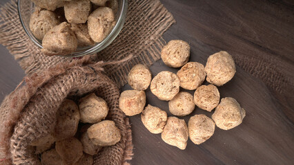 Raw soya chunks on dark background. Healthy, nutritious soybean meat, chunks isolated.Vegan food concept.