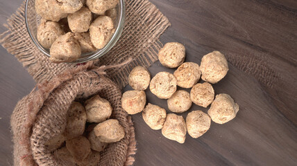 Raw soya chunks on dark background. Healthy, nutritious soybean meat, chunks isolated.Vegan food concept.