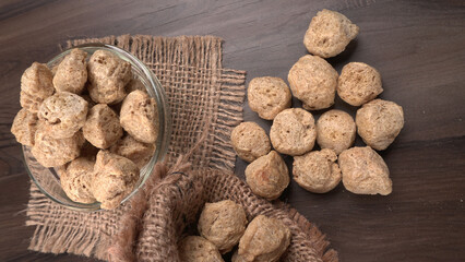 Raw soya chunks on dark background. Healthy, nutritious soybean meat, chunks isolated.Vegan food concept.