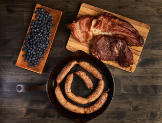 Sausage and pork ham in a cast iron