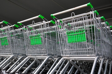 row of empty cart in the supermarket . Shopping center background